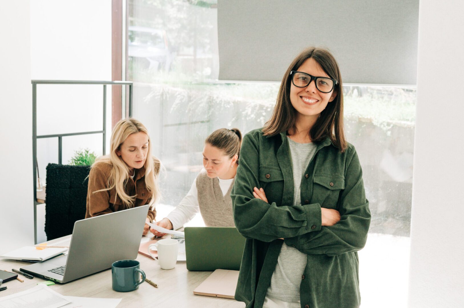 Confident woman smiling in office setting.